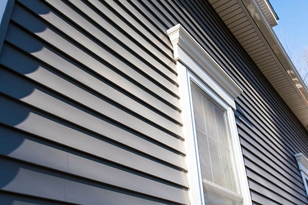 A home with navy blue siding that looks brand new