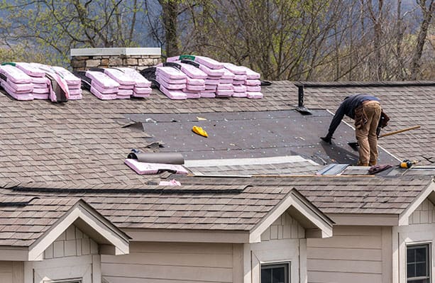 roofers replacing a home's roof