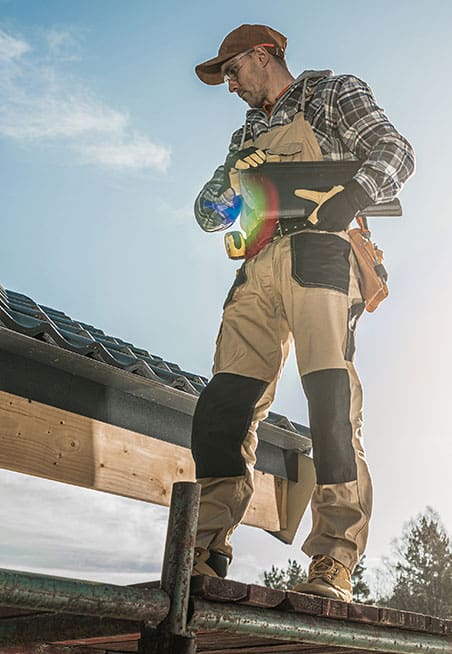 Maintenance worker standing on a roof.