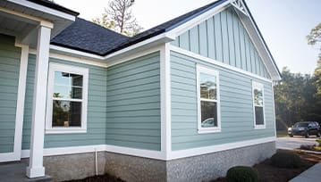 Front view of a brand new construction house with blue siding